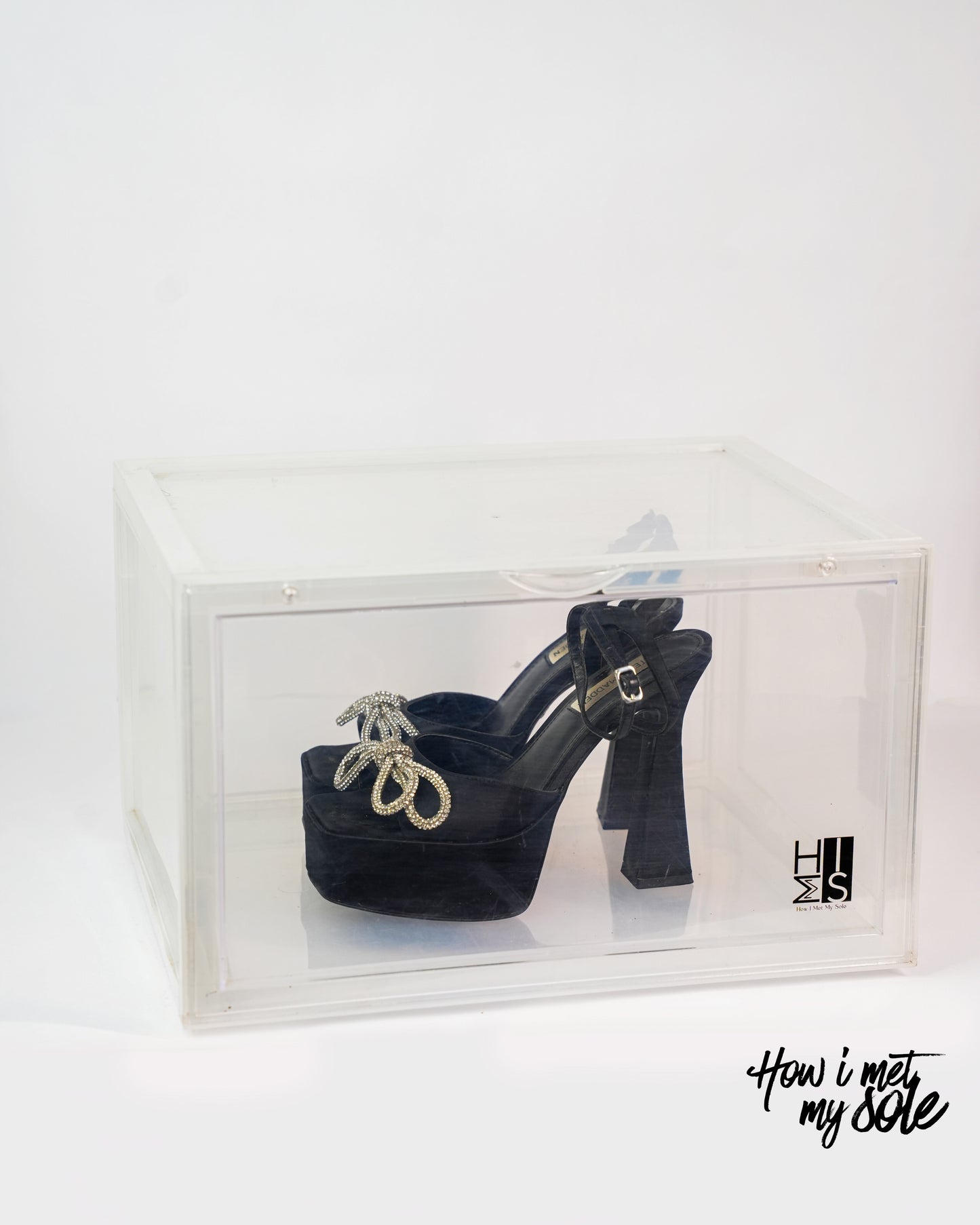 Black high-heeled shoes in a clear style safe storage on a white background