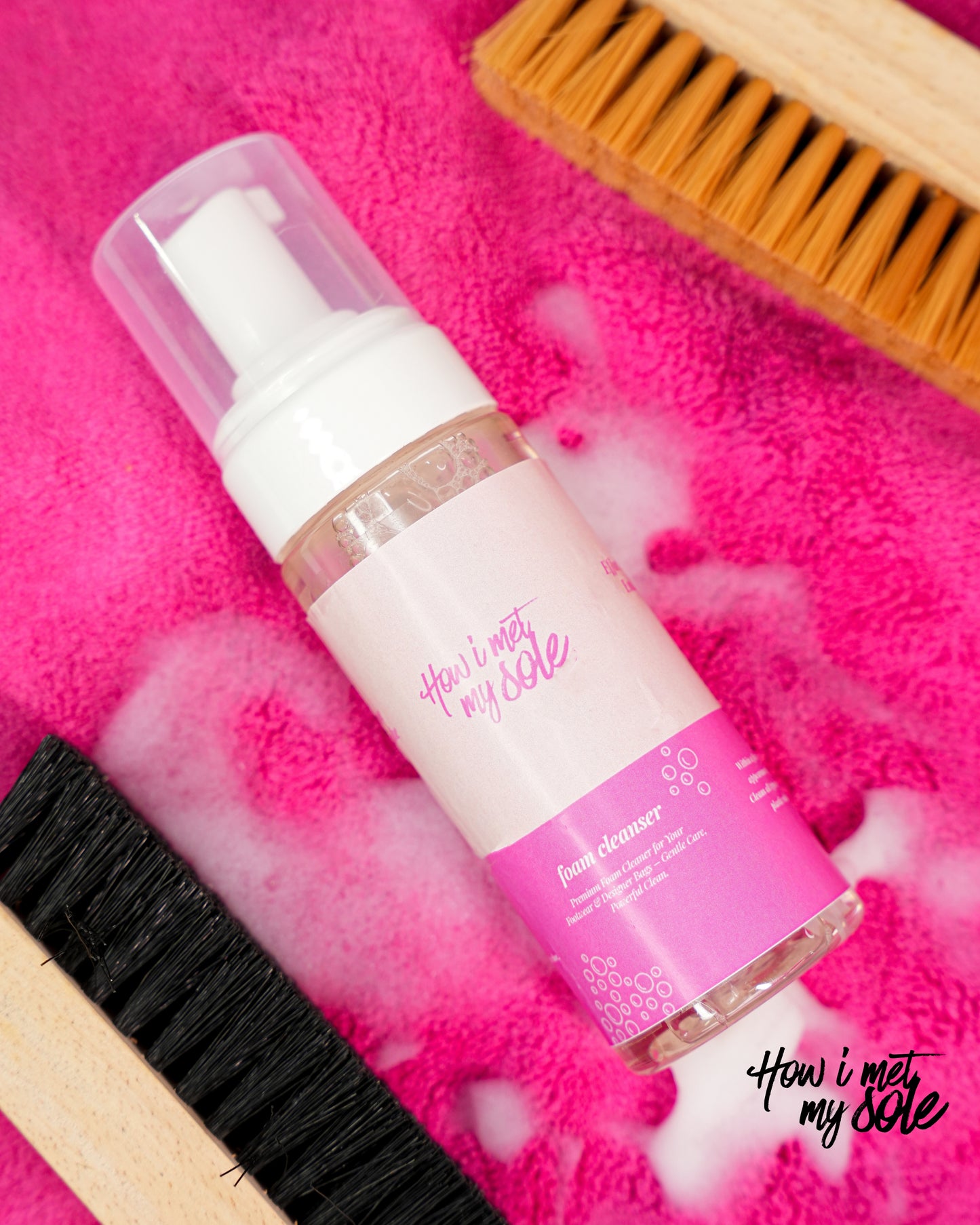 Foam cleaner bottle with brushes on the pink microfiber cloth