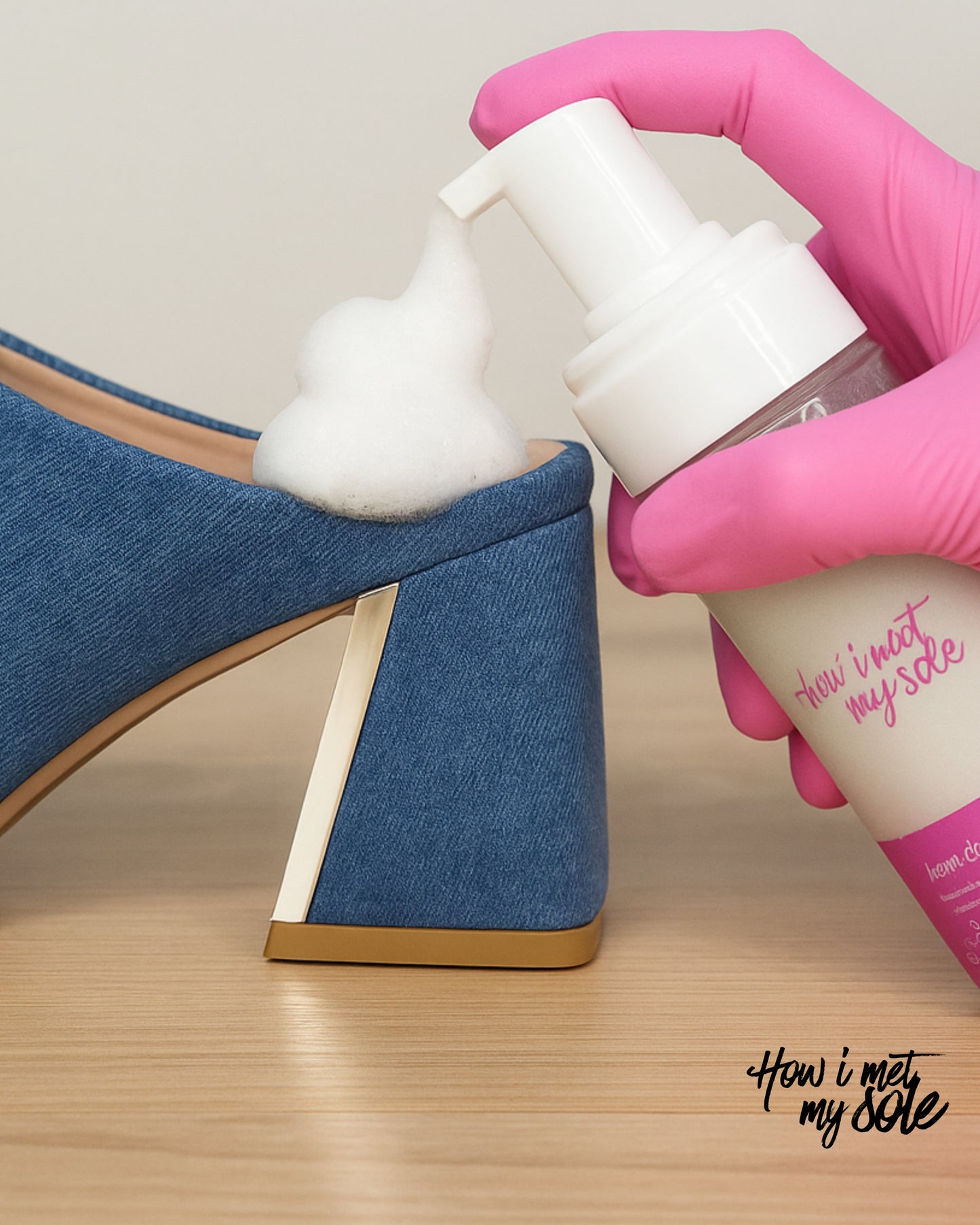 Person applying foam cleaner to a blue denim heel