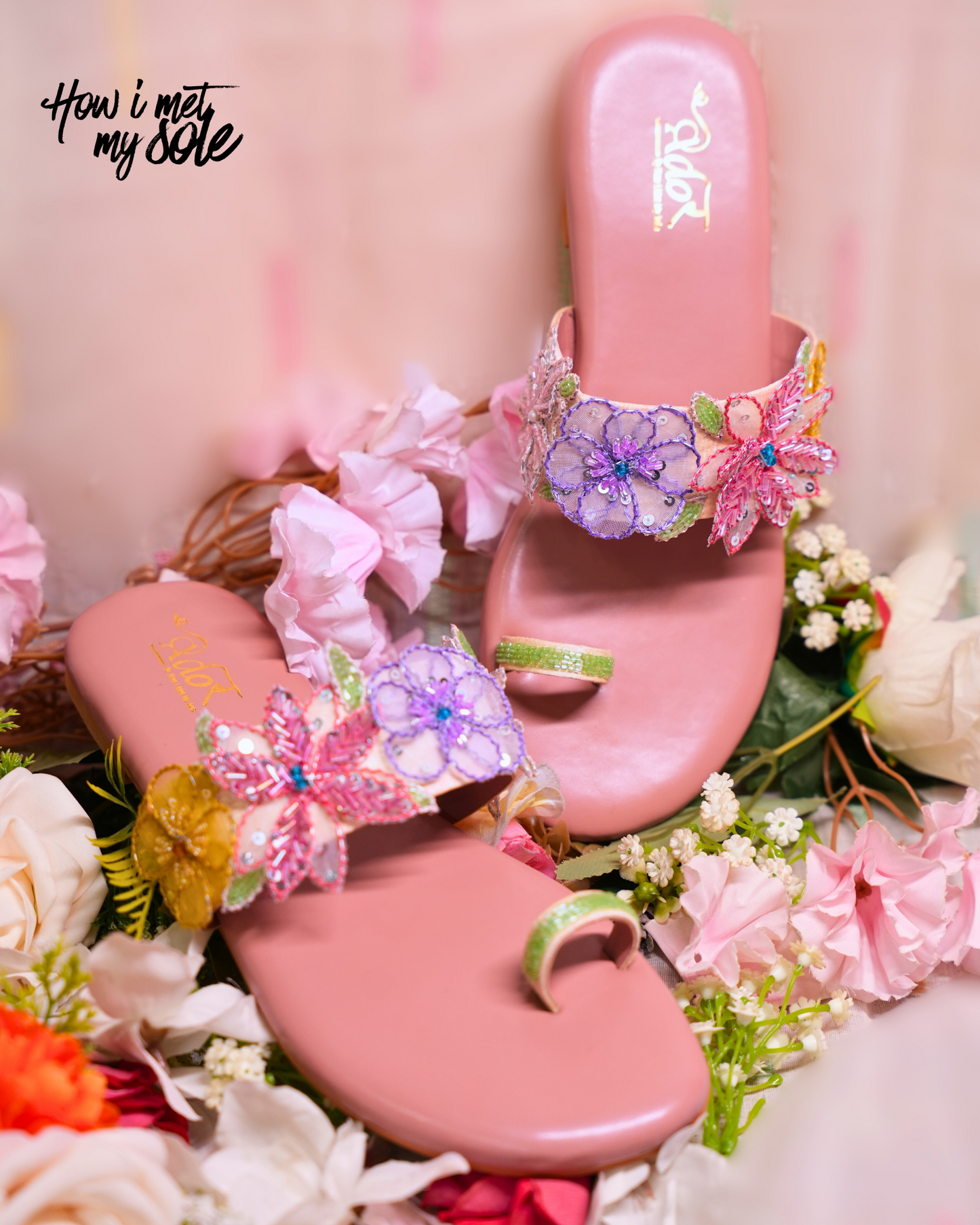 Pink sandals with floral decorations on a floral background