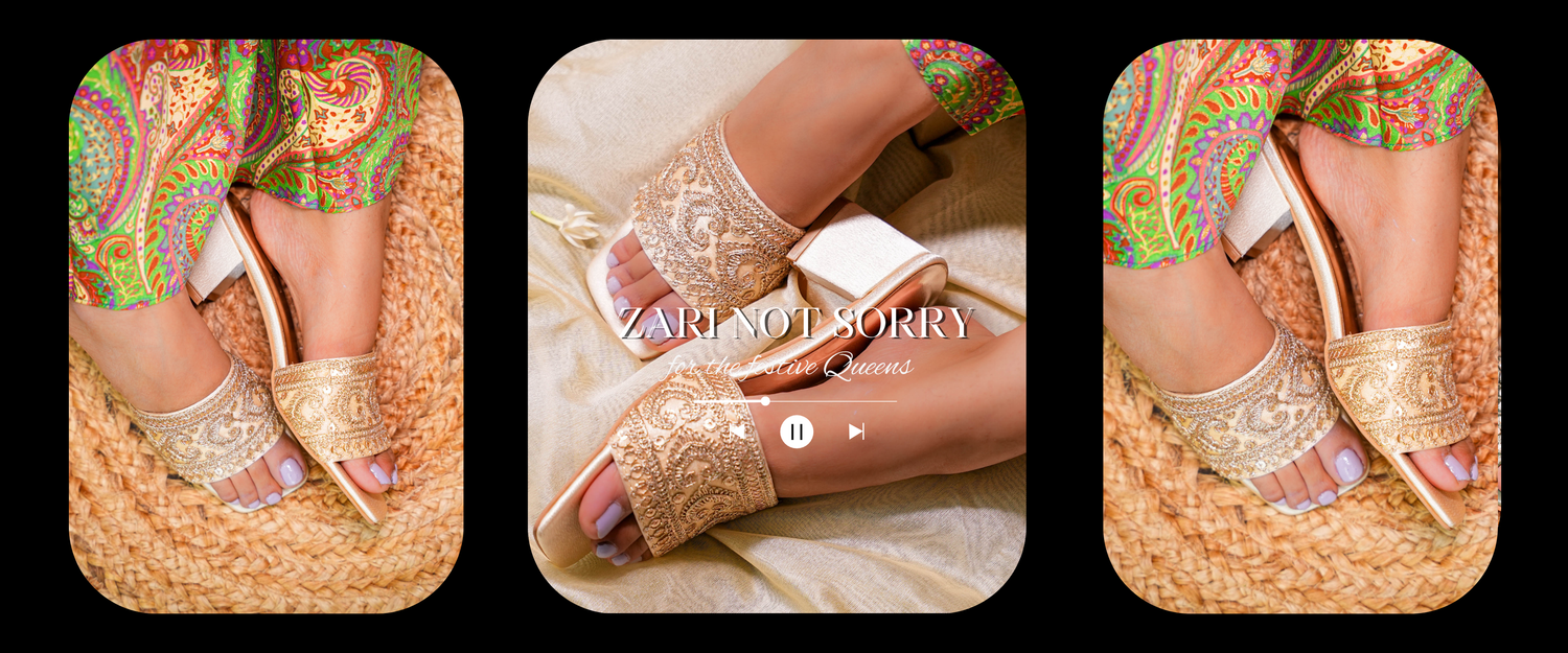 Gold open-toe kohlapuri heel shoes with colorful patterns worn by a person, displayed against a black background.