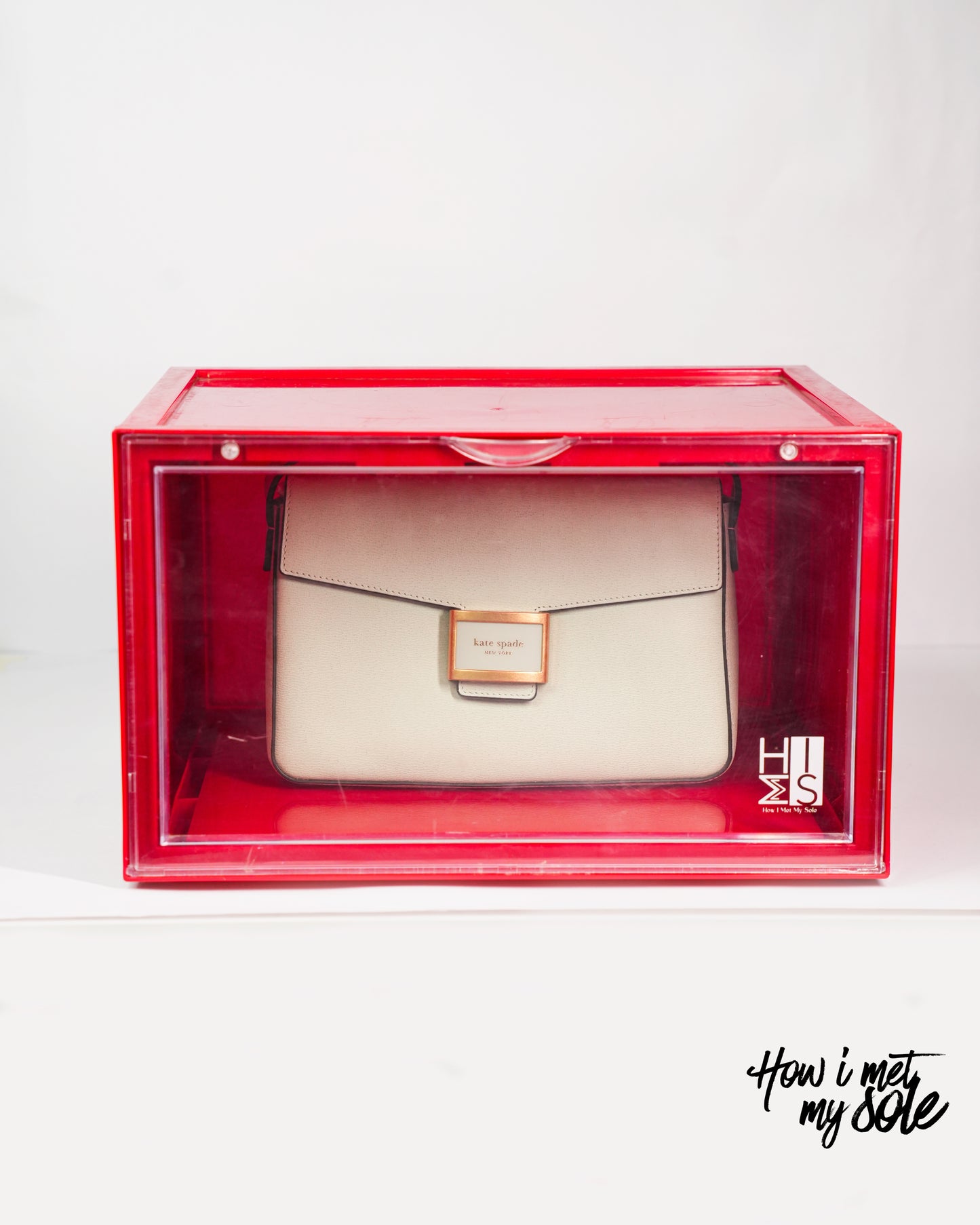 White luxury handbag in a red style safe storage box with 'How i met my sole' branding