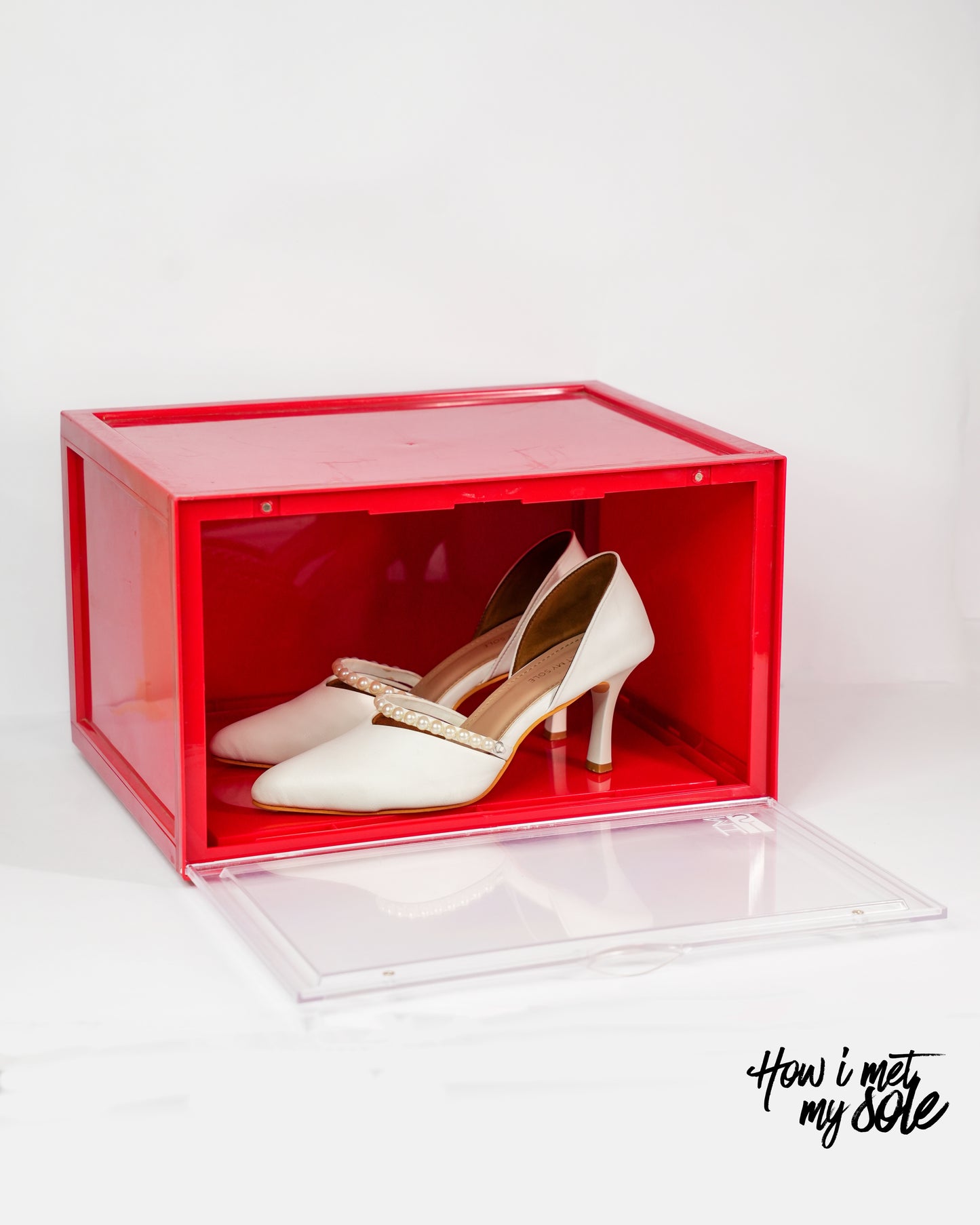Red style safe storage box with white luxury high heels inside