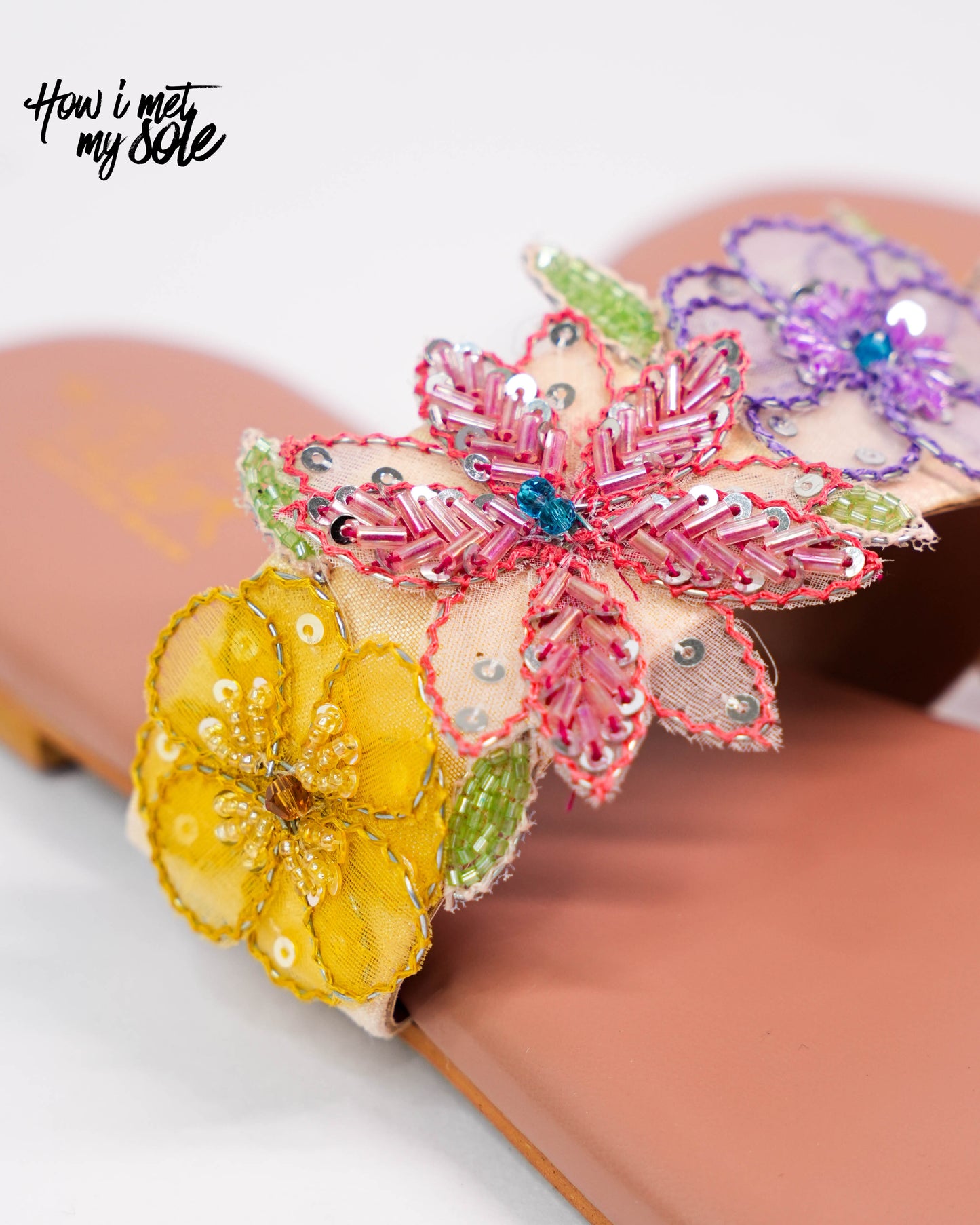 Decorative sandal with colorful flowers on a white background