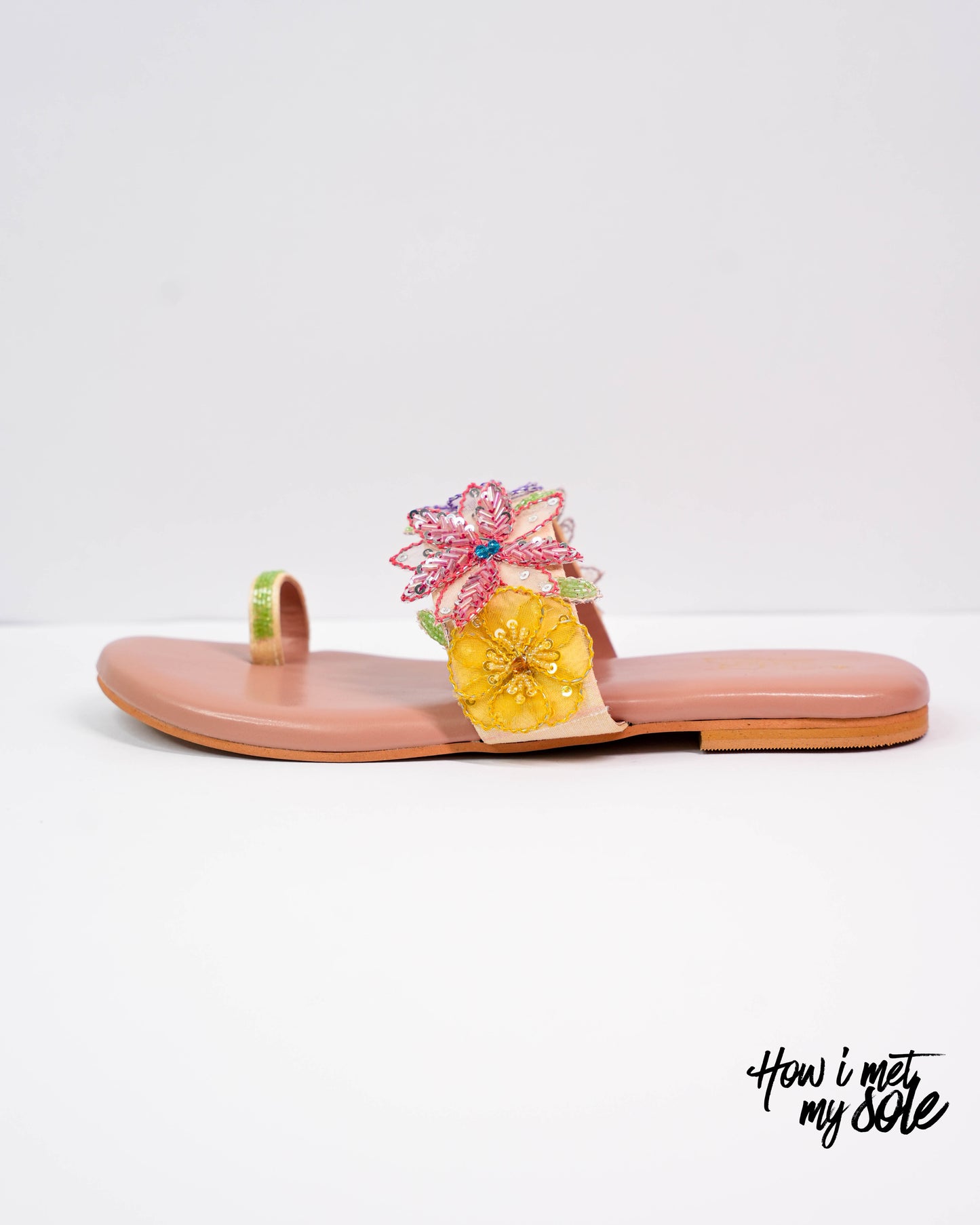 Floral sandal with a pink strap on a white background